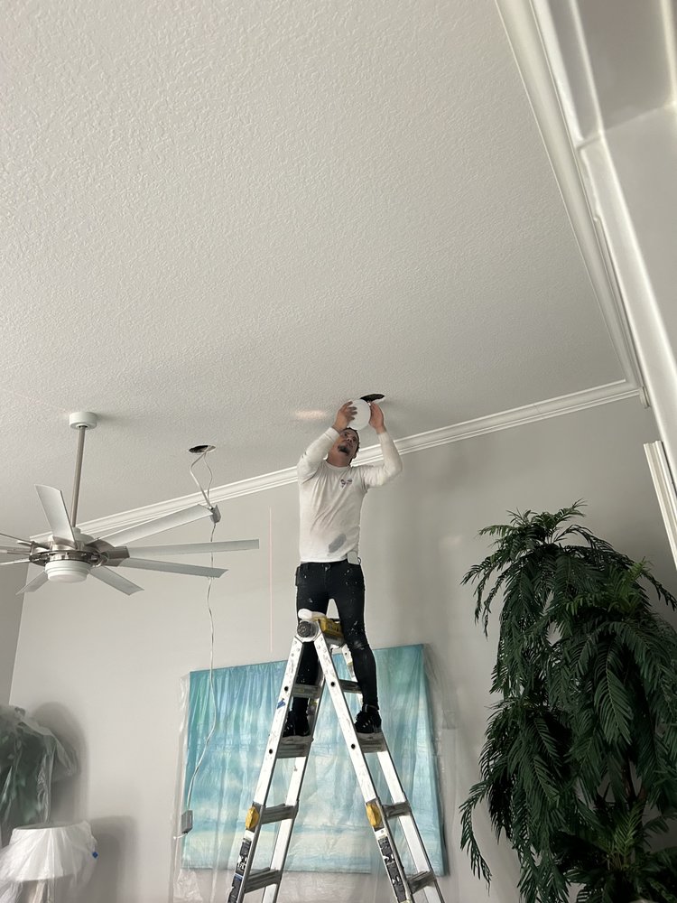 Home AMR worker completing ceiling lighting installation